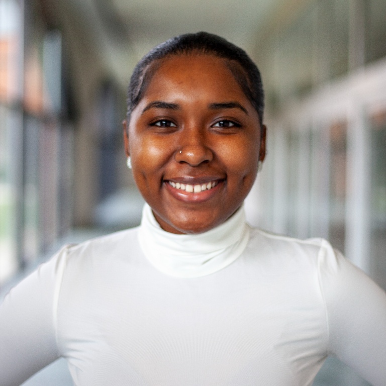 Jayla Jones smiles at the camera with arms on hips