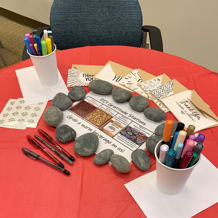 A table is setup with directions and crafting supplies for a JLN gratitude workshop